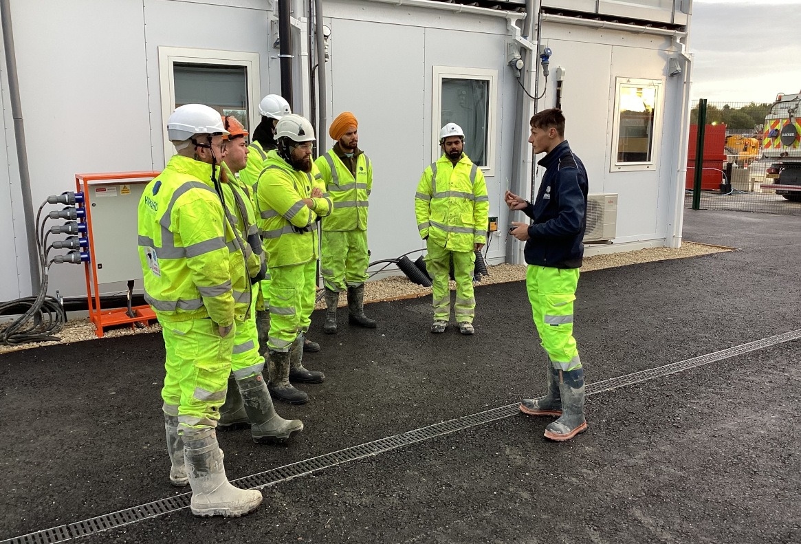 Howard Civil Engineering operatives on the Sunderland site having a toolbox talk about how to use R-Link, their new HAVS monitoring smart watches